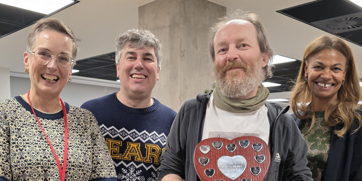 Picture of Jim holding the award alongside OIA leadership