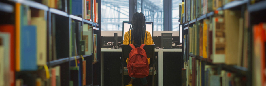 Postgraduate Students Banner Image of a student working in a library